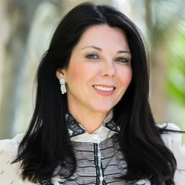 A woman with long black hair wearing a white shirt.