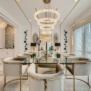 A dining room with white chairs and a glass table.