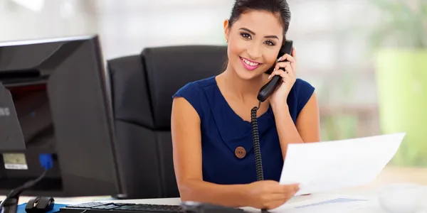 A woman holding a phone to her ear.