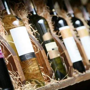 A wooden crate holding bottles of wine and other wines.