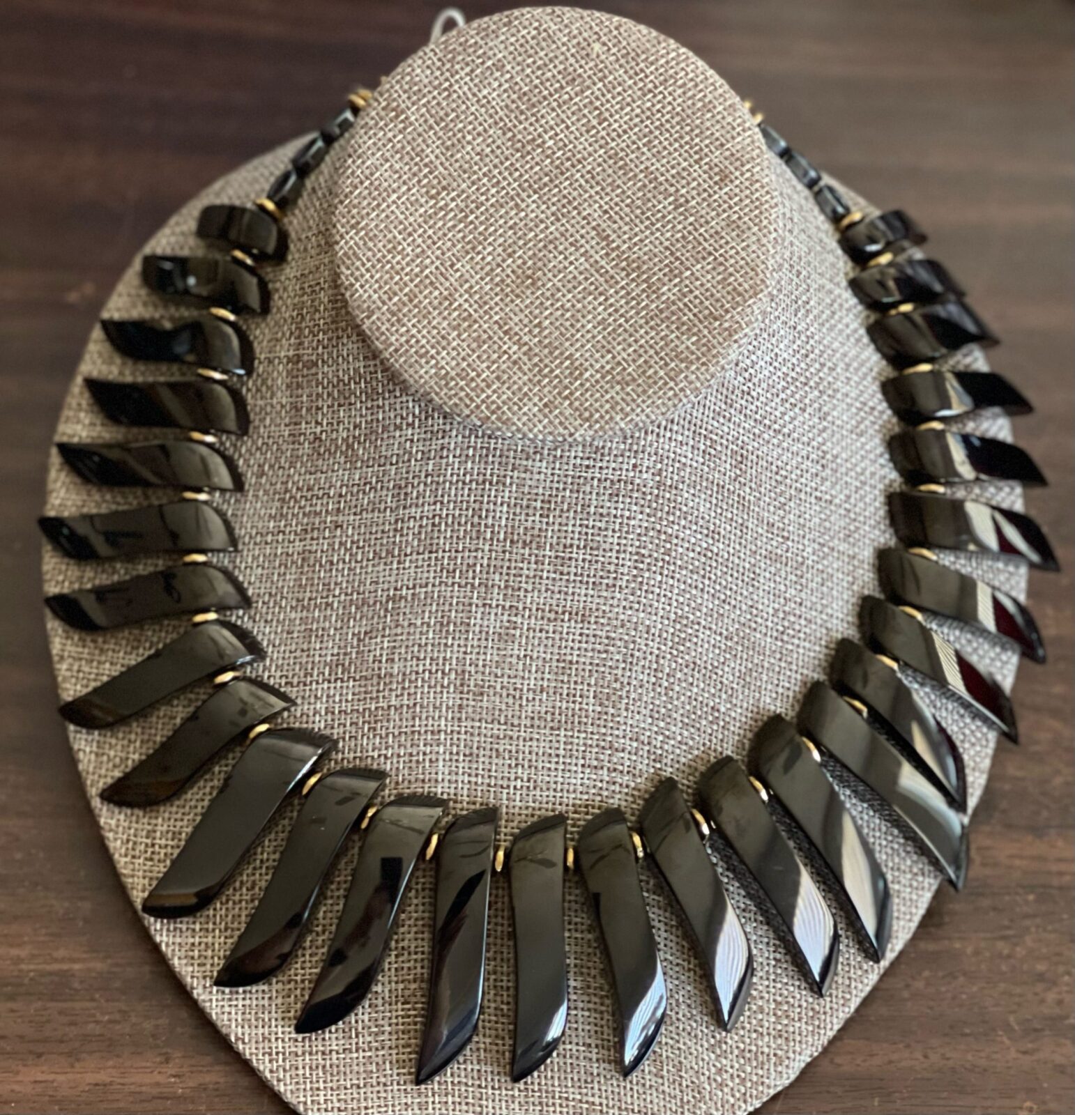 A necklace is displayed on the table.
