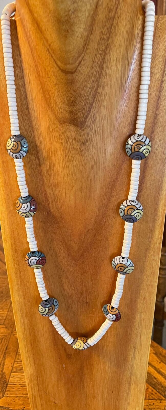 A wooden table with a necklace on it